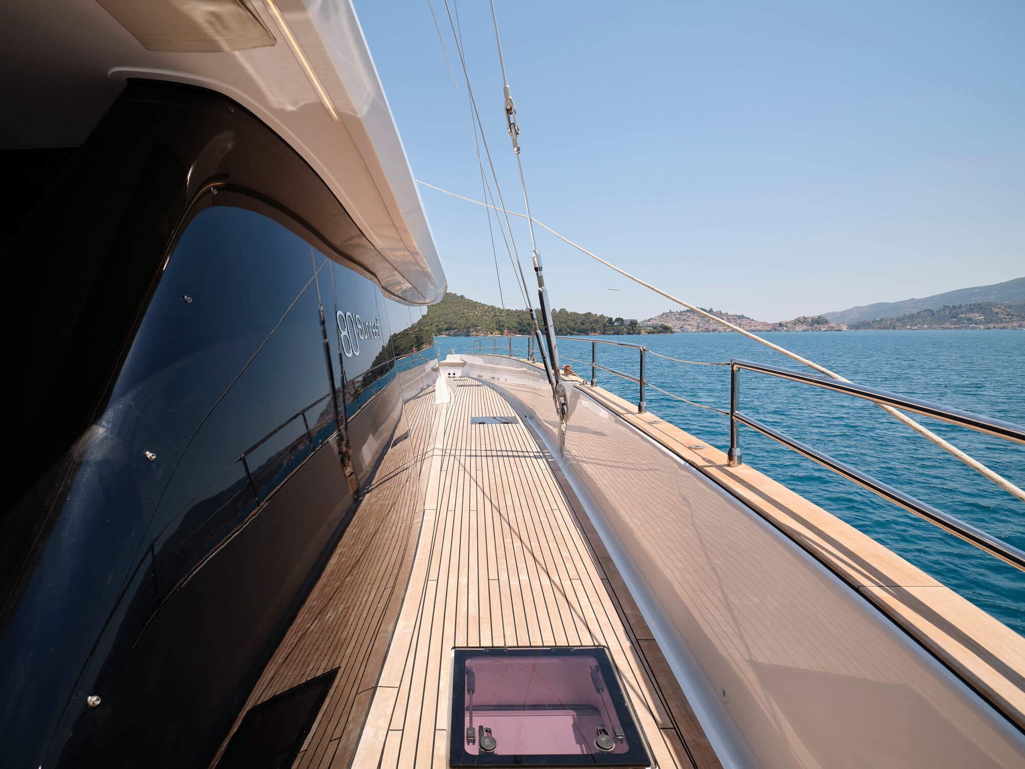 Teak side deck of a charter yacht underway